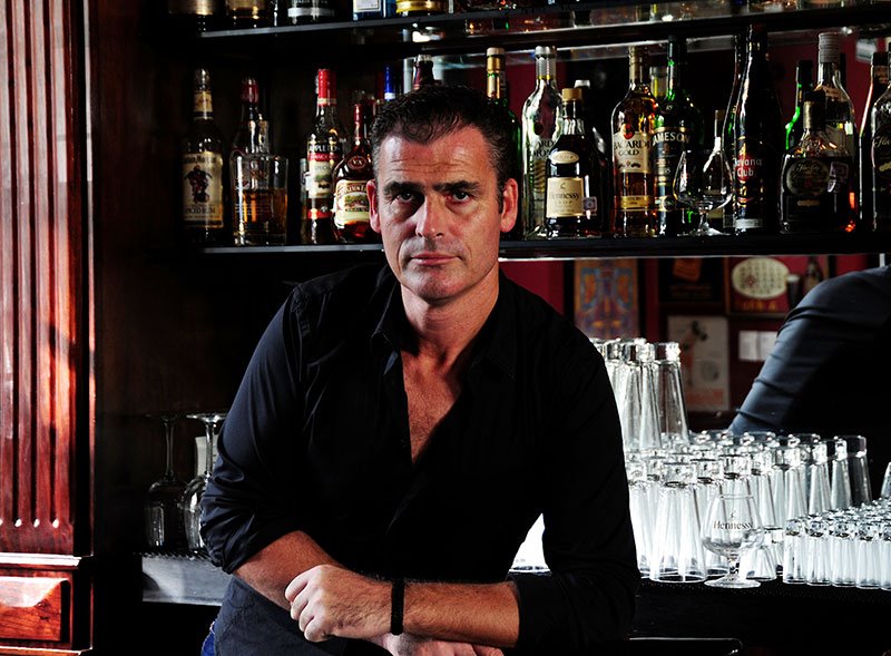 Polo Magazine photo from Alex Webbe of bar tender in black shirt